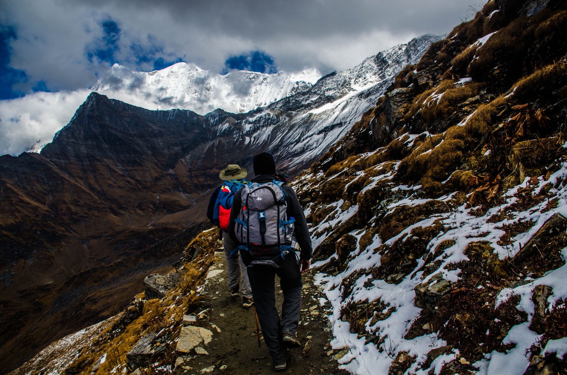 Trekker walking gently across vast steppe landscape towards granite mountains